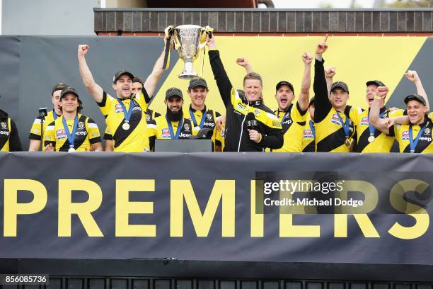 Trent Cotchin of the Tigers and Tigers head coach Damien Hardwick lift up the Premiership cup as players celebrate winning yesterday's AFL Grand...