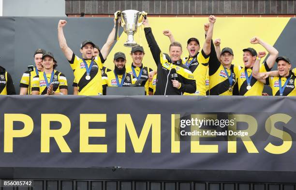 Trent Cotchin of the Tigers and Tigers head coach Damien Hardwick lift up the Premiership cup as players celebrate winning yesterday's AFL Grand...