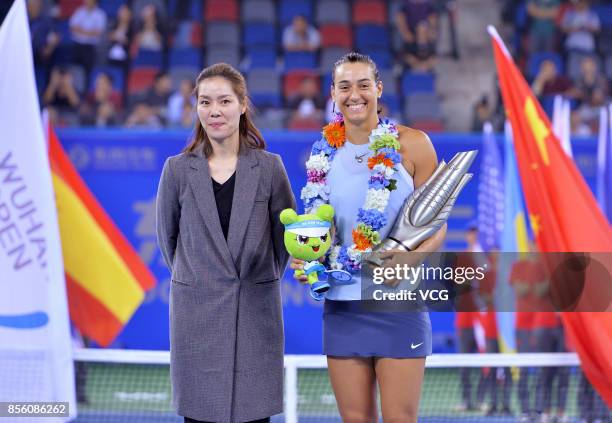 Caroline Garcia of France receives trophy from former Chinese tennis player Li Na after winning the ladies singles final against Ashleigh Barty of...
