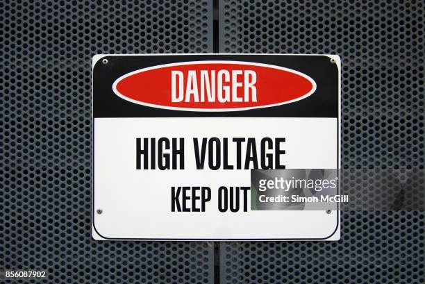 'danger: high voltage - keep out' sign on a metal housing for electric equipment - keep out sign fotografías e imágenes de stock