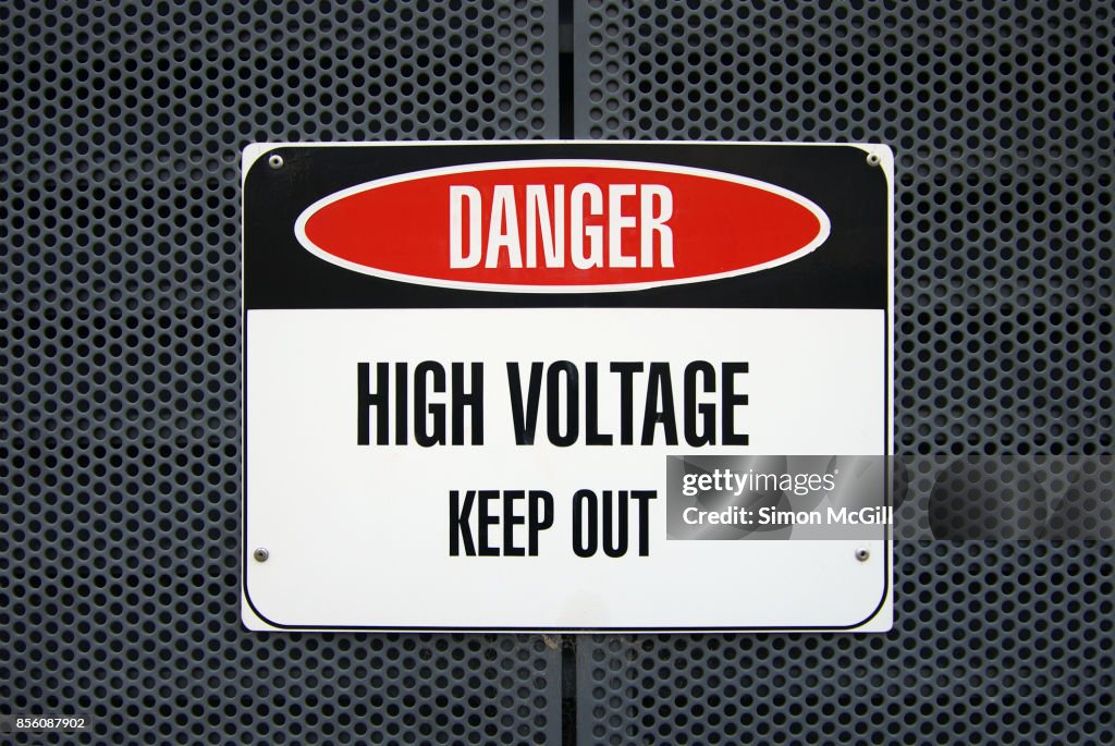 'Danger: High Voltage - Keep Out' sign on a metal housing for electric equipment
