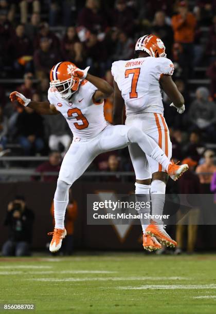 Austin Bryant of the Clemson Tigers celebrates with teammates after an interception during the fourth quarter against the Virginia Tech Hokies at...