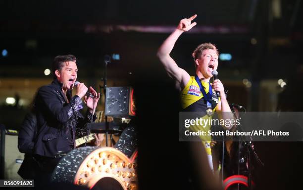 Jack Riewoldt of the Tigers sings on stage with Brandon Flowers and The Killers during the Virgin Australia Premiership Party after the 2017 AFL...