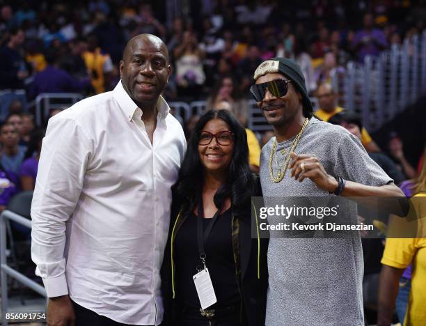 Rapper Snoop Dogg poses with Earvin "Magic" Johnson, president of basketball operations of the Los Angeles Lakers, and his wife Cookie Johnson as...