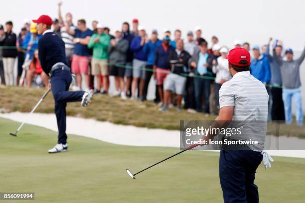 Golfer Jordan Spieth and Patrick Reed react after Reed makes a putt on the 16th hole during the third round of the Presidents Cup at Liberty National...
