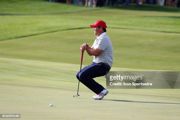 Golfer Patrick Reed reacts to missing a putt on the 8th hole during the third round of the Presidents Cup at Liberty National Golf Club on September...
