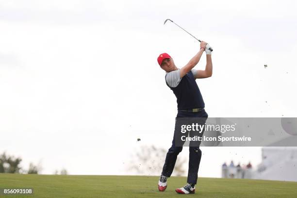 Golfer Justin Thomas hits his second shot on the 17th hole during the third round of the Presidents Cup at Liberty National Golf Club on September...