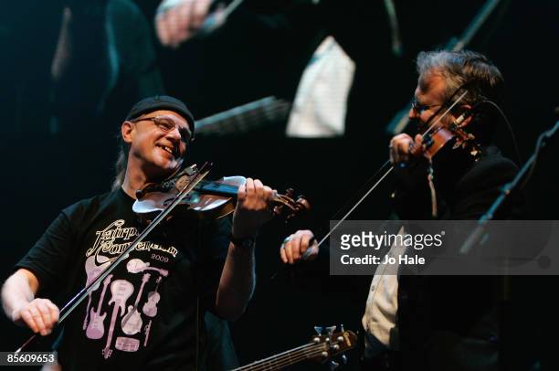 Violinists Richard 'Ric' Sanders and Chris Leslie of English folk band Fairport Convention perform live on stage during the second night of a series...