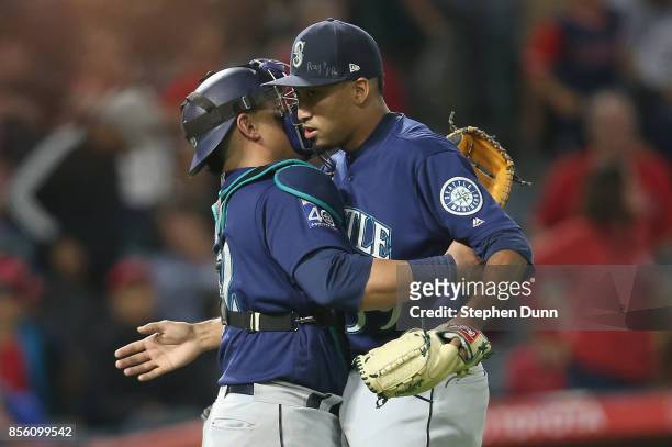 Reliever Edwin Diaz and catcher Carlos Ruiz of the Seattle Mariners celebrate after Diaz pitched the ninth inning to pick up the save against the Los...