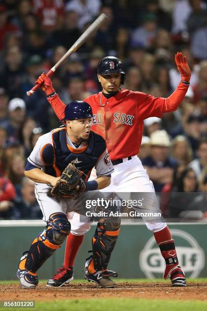 Mookie Betts of the Boston Red Sox looks on as Juan Centeno of the Houston Astros trows to second base in the eighth inning of a game at Fenway Park...