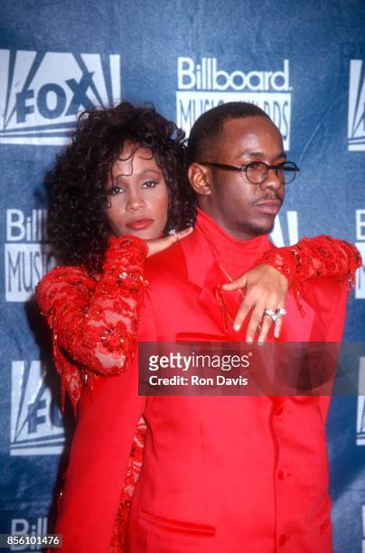 American singer and actress Whitney Houston hugs her husband Bobby Brown in the Press Room at the 1993 Billboard Music Awards on December 8, 1993 at...
