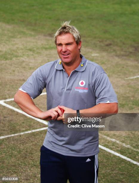 Australian cricket legend Shane Warne prepares to bowl to McLaren Mercedes drivers Heikki Kovalainen of Finland and Lewis Hamilton of Great Britain...