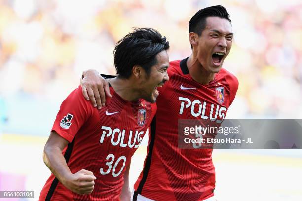 Shinzo Koroki of Urawa Red Diamonds celebrates scoring the opening goal with his team mate Tomoaki Makino during the J.League J1 match between...