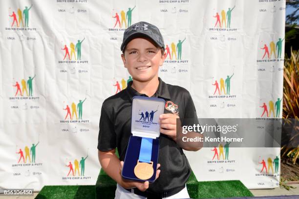 First place putting boys 12-13 Logan Gonzalez poses during a regional round of the Drive, Chip and Putt Championship at Torrey Pines Golf Course on...