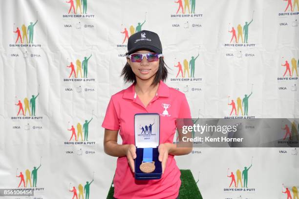 First place driving skills for girls age 12-13 category Catherine Rao pose with their medals during a regional round of the Drive, Chip and Putt...