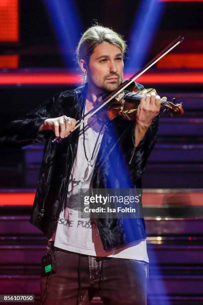 Violinist David Garrett performs during the tv show 'Willkommen bei Carmen Nebel' at TUI Arena on September 30, 2017 in Hanover, Germany.