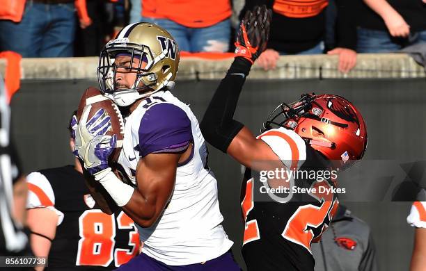 Wide receiver Quinten Pounds of the Washington Huskies catches a pass as cornerback Isaiah Dunn of the Oregon State Beavers defends during the first...