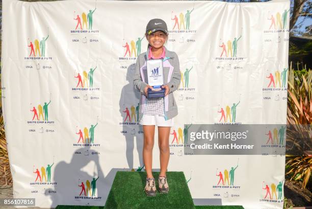 First place chipping skills for girls age 7-9 category Mia Nakaoka poses with her medal during a regional round of the Drive, Chip and Putt...