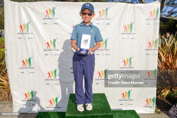 First place driving skills for boys age 7-9 category Evan Liu poses with his medal during a regional round of the Drive, Chip and Putt Championship...