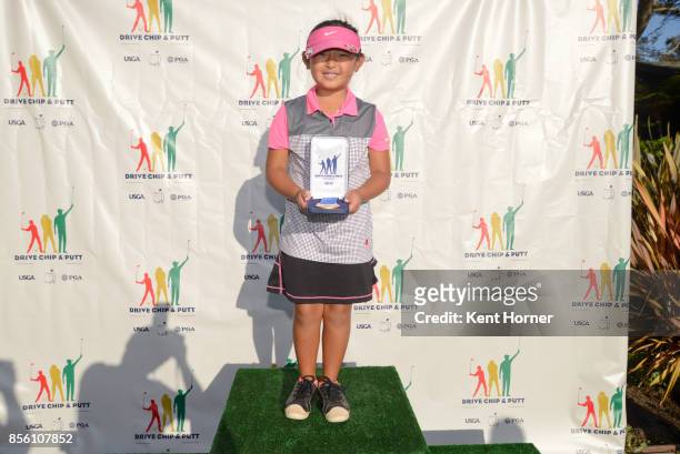 First place putting skills for girls age 7-9 category Kady Matsumoto poses with her medal during a regional round of the Drive, Chip and Putt...
