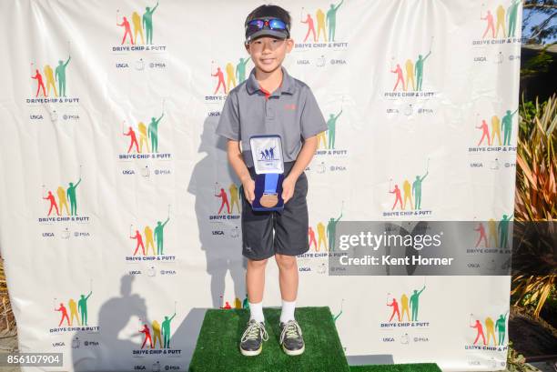 First place chipping skills for boys age 7-9 category Cole Kim poses with his medal during a regional round of the Drive, Chip and Putt Championship...