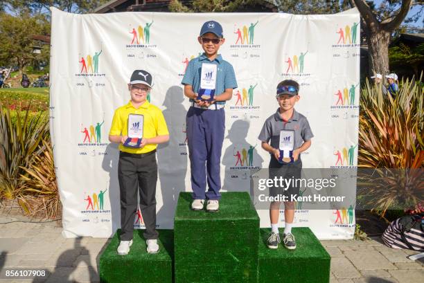 Second, first and third place driving skills for boys age 7-9 category Alekzander Altizer, left, Evan Liu, center, and Cole Kim pose with their...