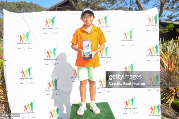 First place chipping skills for boys age 10-11 category Kai Hirayama poses with his medal during a regional round of the Drive, Chip and Putt...