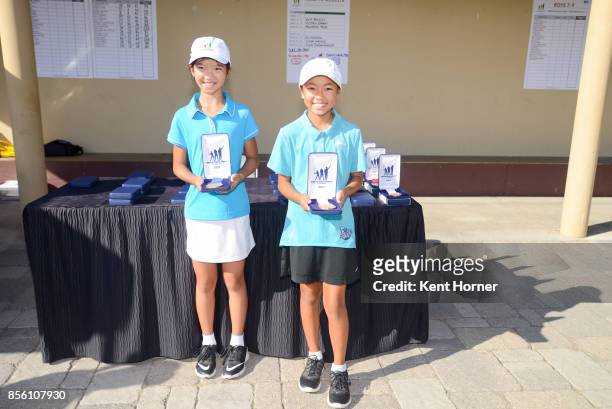 Frst and third place chipping skills for girls age 10-11 category Bridget Chantharath, left, and Kate Nakoaka pose with their medals during a...