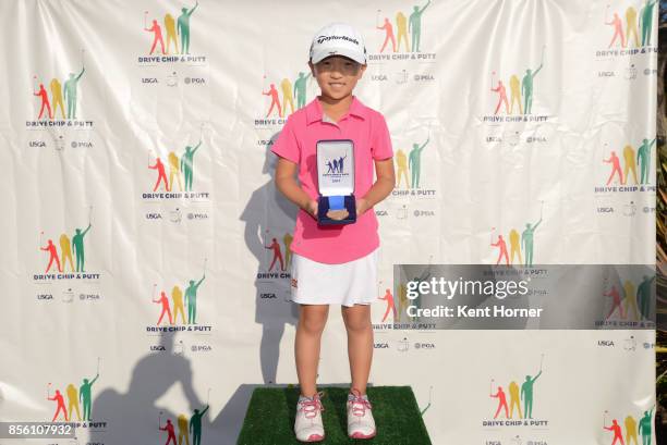 First place driving skills for girls age 7-9 category Anna Fang poses with her medal during a regional round of the Drive, Chip and Putt Championship...