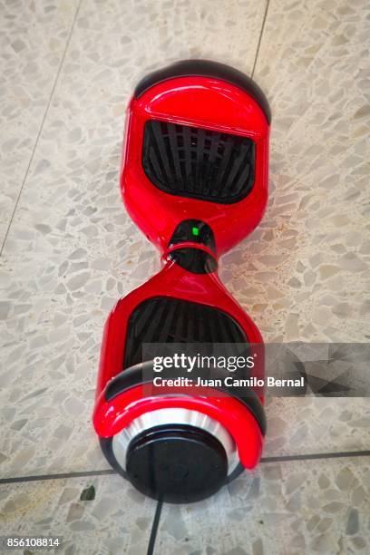 red hoverboard on the floor - hover board ストックフォトと画像