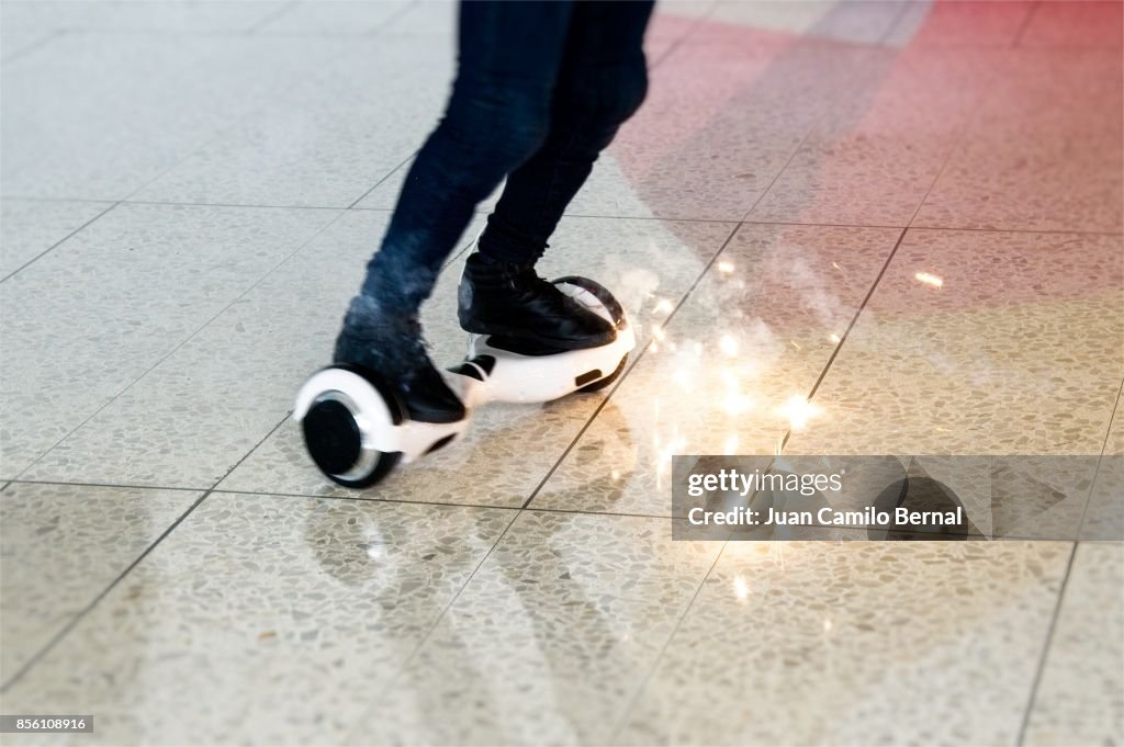 Legs of woman riding a burning hoverboard