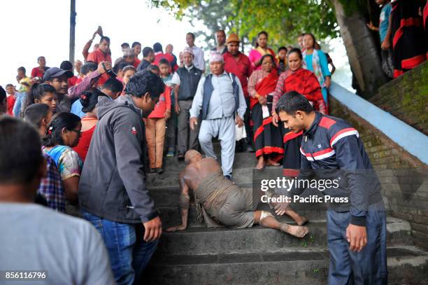 Nepalese devotee rolls on the ground to offer ritual prayer during the tenth day of Dashain Durga Puja Festival in Bramayani Temple, Bhaktapur, Nepal...