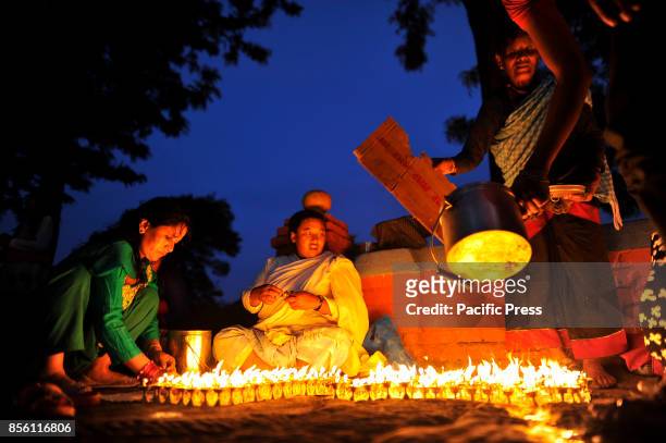Nepalese Devotee offering butter lamps infornt Bramayani Temple during the tenth day of Dashain Durga Puja Festival in Bramayani Temple, Bhaktapur,...