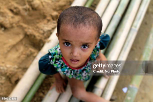 Coxs Bazar, Bangladesh. September 24, 2017. Rohingya refugee child sits at a refugee camp in Coxs Bazar, Bangladesh on September 24, 2017. Over...