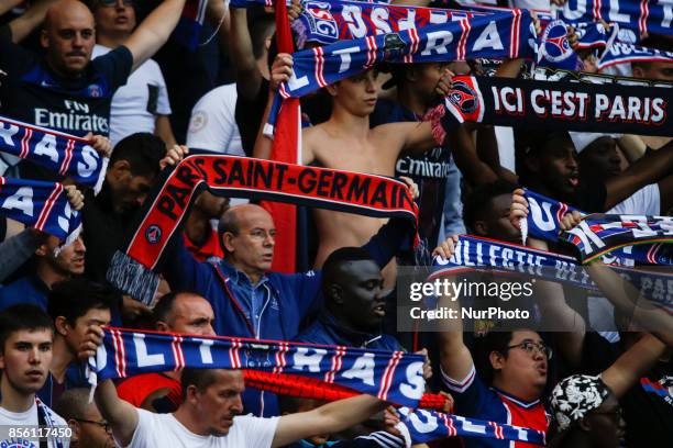 Paris Saint-Germain's fans hold scarves during the French L1 football match between Paris Saint-Germain and Bordeaux at the Parc des Princes stadium...