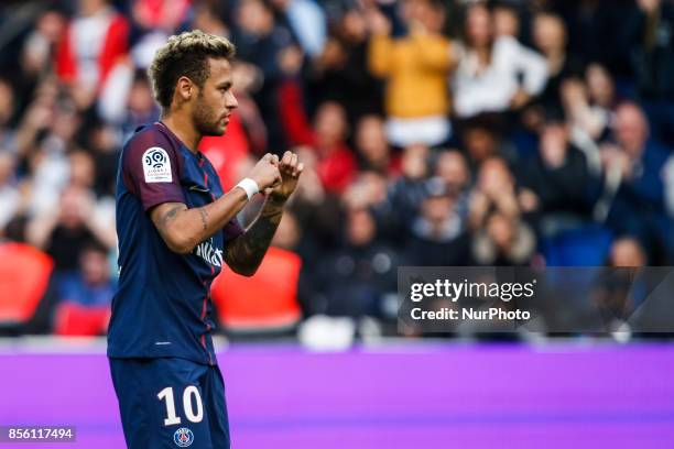 Paris Saint-Germain's Brazilian forward Neymar recats after he scored a penalty kick during the French L1 football match Paris Saint-Germain vs...