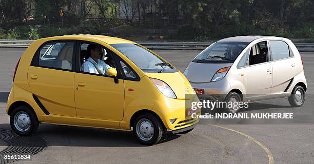 India-company-auto-Tata-Nano,SCENE by Phil Hazlewood A Tata Motors employee drives a Nano car as he parks ahead of a test drive session for...