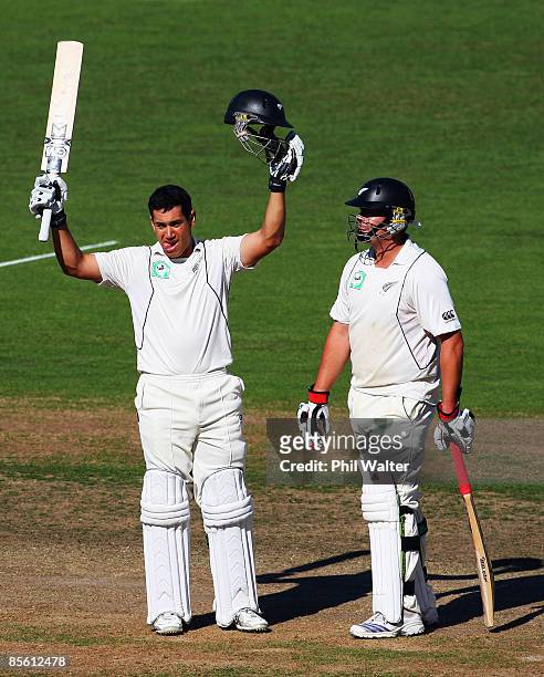 Ross Taylor of New Zealand celebrates reaching his century as team-mate Jesse Ryder looks on during day one of the second test match between New...