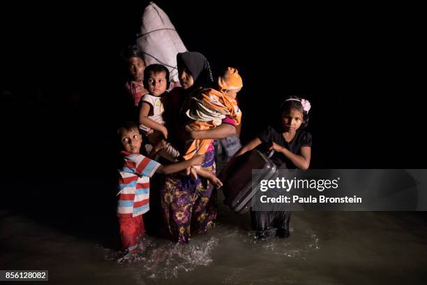 Boats full of people continue to arrive along the shores of the Naf River as Rohingya come in the safety of darkness September 30, 2017 on Shah Porir...