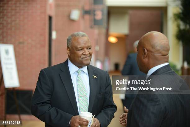 Prince George's County Executive Rushern Baker, left, speaks to Ron Cooper, president of the National Association of Real Estate Brokers while...