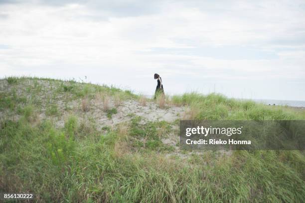 woman walking in nature - rieko honma stock-fotos und bilder