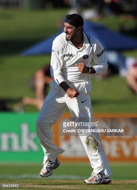 Indian cricketer Harbhajan Singh celebrates after taking the wicket of unseen New Zealand batsman Ross Taylor during the first day of the second Test...