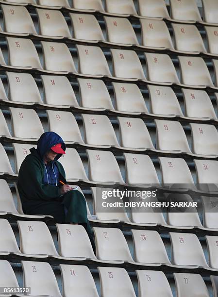 New Zealand cricket fan relaxes as he watches the match from the gallery during the first day of the second Test match at the McLean Park in Napier...