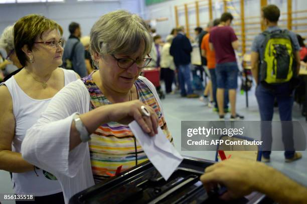 Woman casts her ballot in a polling station in Barcelona, on October 1 on the day of a referendum on independence for Catalonia banned by Madrid....