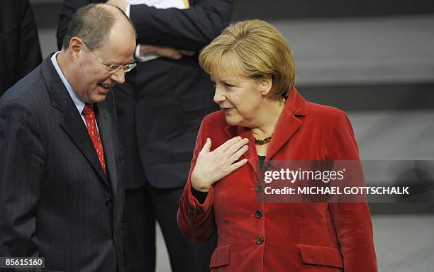 German Chancellor Angela Merkel chats with German Finance minister Peer Steinbrueck at the Bundestag lower house of parliament on March 26, 2009 in...