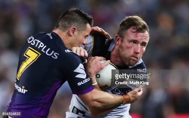 Gavin Cooper of the Cowboys is tackled by Cooper Cronk of the Storm during the 2017 NRL Grand Final match between the Melbourne Storm and the North...