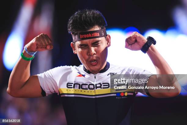 An athlete celebrates as he arrives to the finish line of the IRONMAN Barcelona on September 30, 2017 in Calella, Barcelona province, Spain.