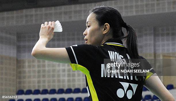 Malaysia's Wong Mew Choo prepares serve against Hong Kong's Mong Kwan Yi during their women's singles match of the Yonex Sunrise India open in...