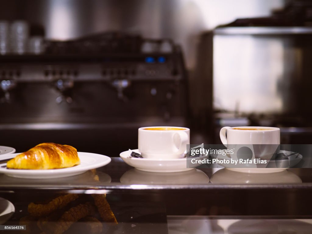 Two cafe latte and croissant in bar