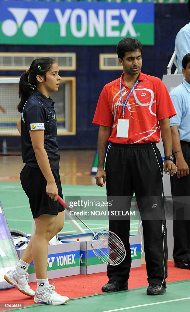 India's Saina Nehwal (L) talks to her co